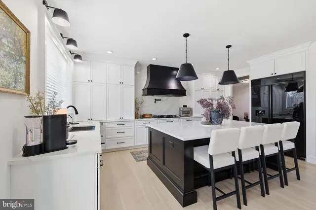 a kitchen with stainless steel appliances a sink stove and refrigerator