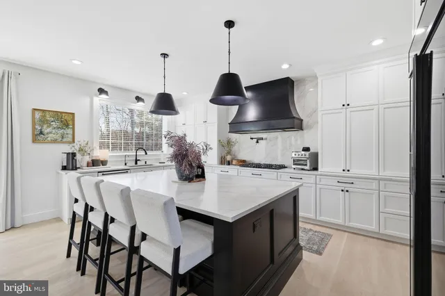 a kitchen with stainless steel appliances a sink stove and refrigerator