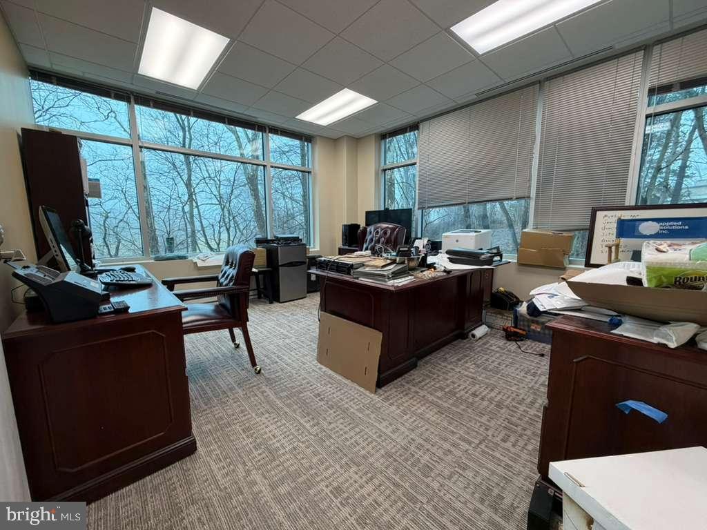 1984 Isaac Newton Square West, Unit 209 Reston, VA 20190 - Photo 2 of 9 a living room with furniture a window and a flat screen tv