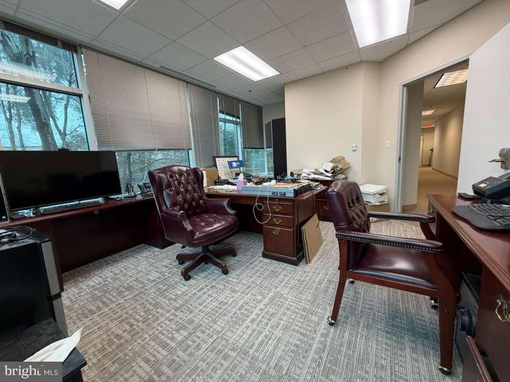 1984 Isaac Newton Square West, Unit 209 Reston, VA 20190 - Photo 3 of 9 a living room with furniture and a flat screen tv