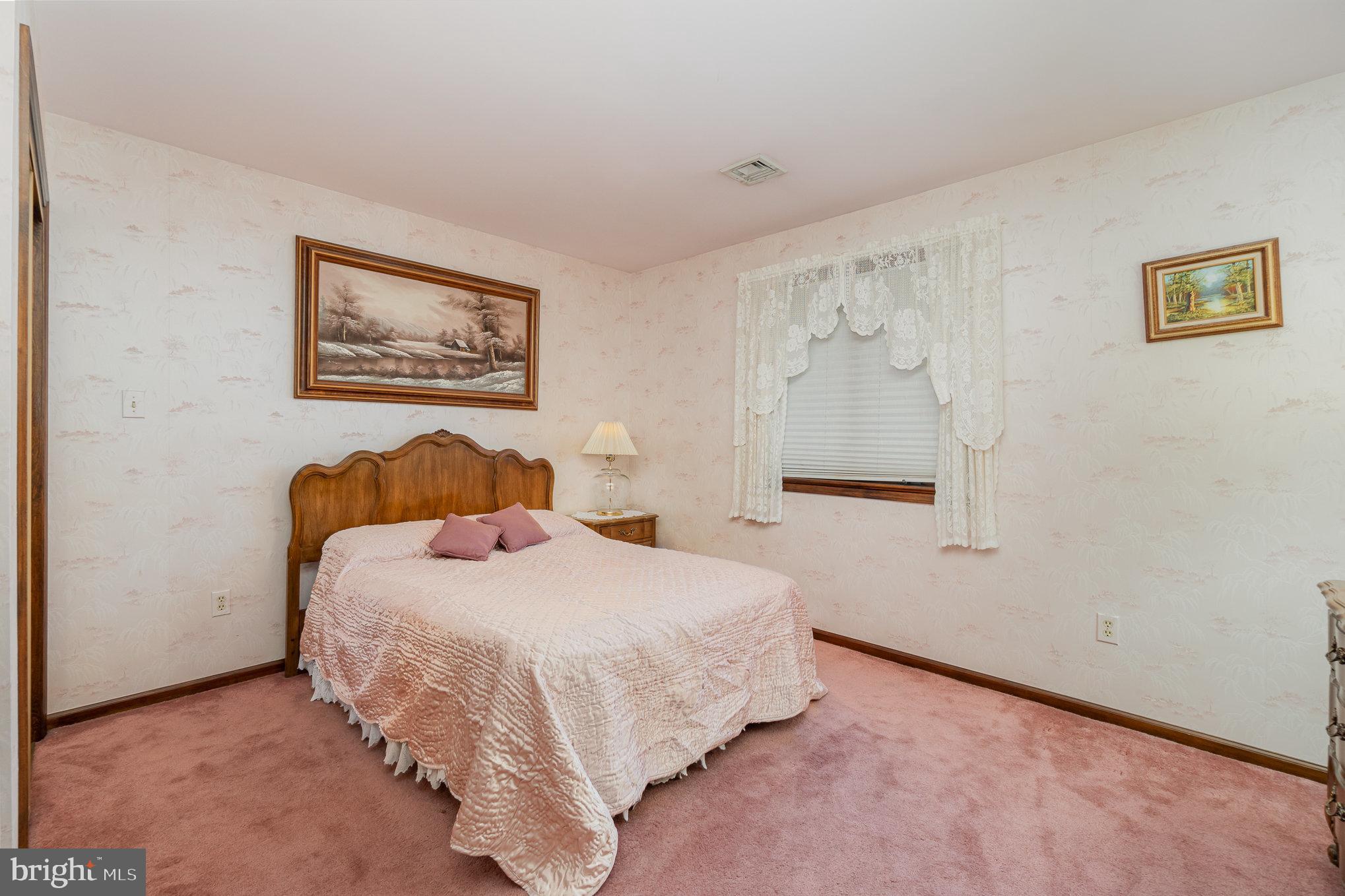 48 Turnpike Road Ashland, PA 17921 - Photo 17 of 60 a bedroom with a bed and a wall painting