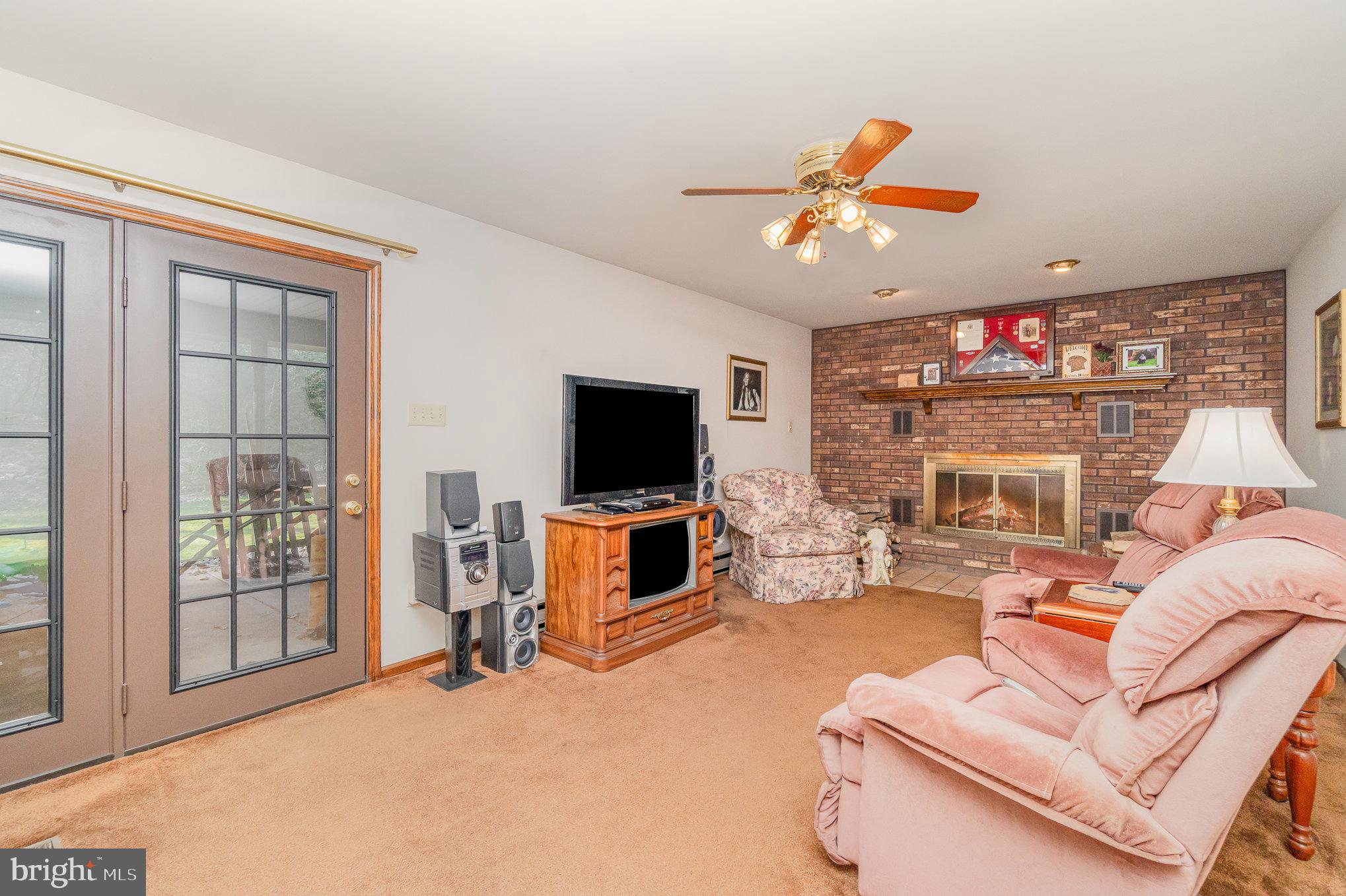48 Turnpike Road Ashland, PA 17921 - Photo 22 of 60 a living room with furniture a flat screen tv and a fireplace