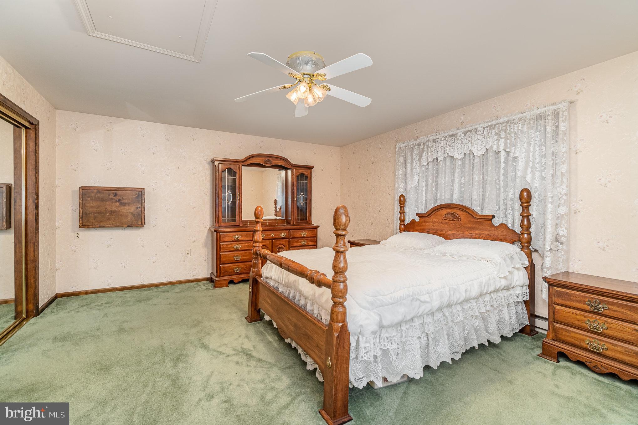 48 Turnpike Road Ashland, PA 17921 - Photo 32 of 60 a bed room with a bed and a chandelier