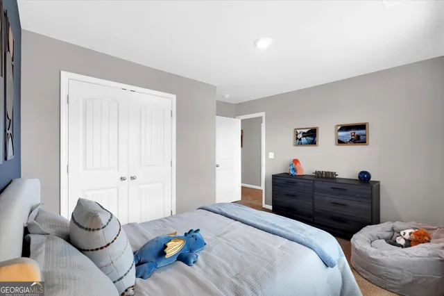 a bedroom with a bed and a potted plant