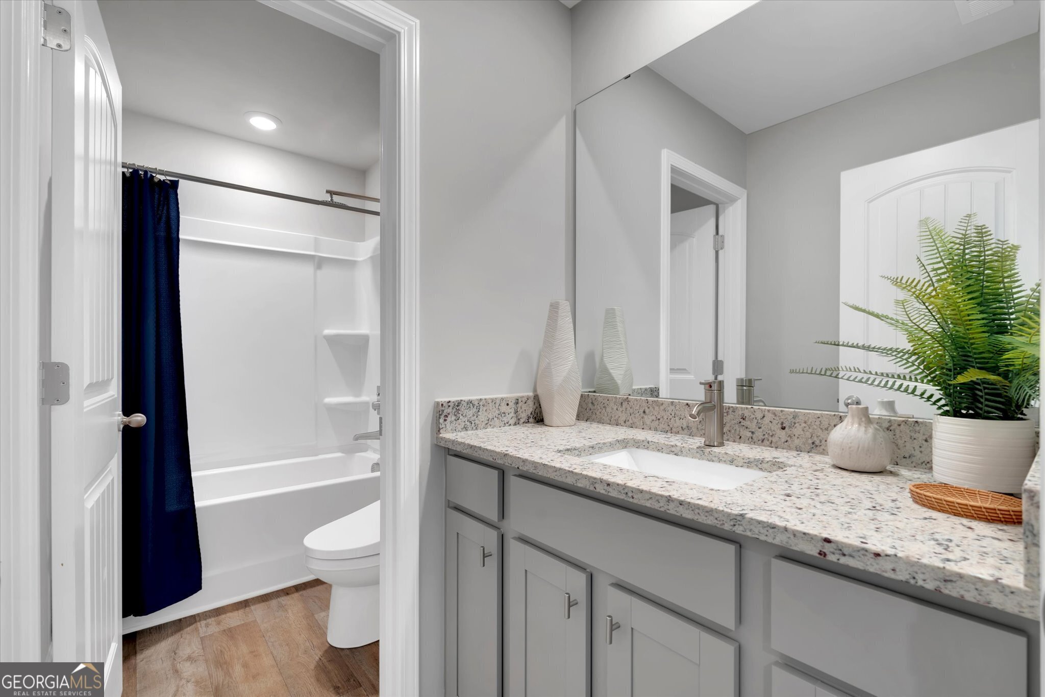 304 Rusty Plow Lane, Unit 22 Perry, GA 31069 - Photo 18 of 25 a bathroom with a granite countertop sink toilet and shower