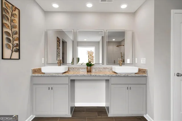 a bathroom with a granite countertop sink and a mirror
