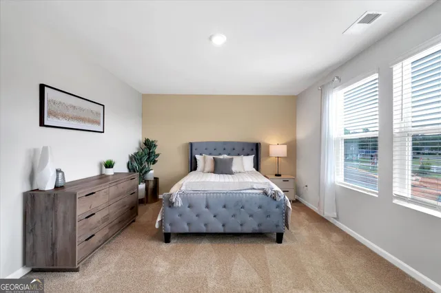 a spacious bedroom with a bed and a window