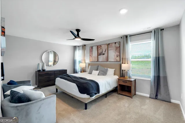 a spacious bedroom with a bed and a chandelier