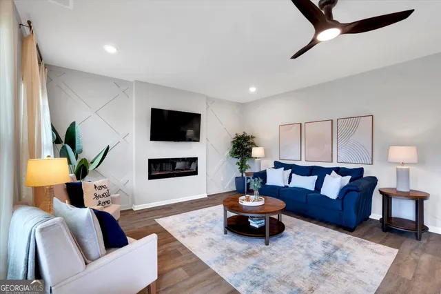 a living room with furniture and a flat screen tv