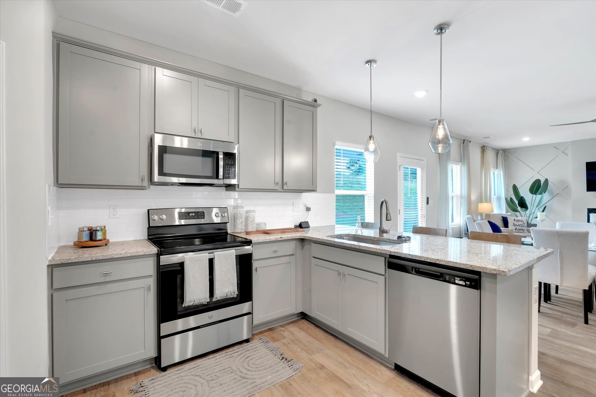 304 Rusty Plow Lane, Unit 22 Perry, GA 31069 - Photo 8 of 25 a kitchen with appliances a sink and cabinets