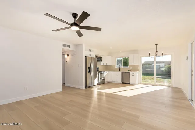 a view of a livingroom with a ceiling fan and window