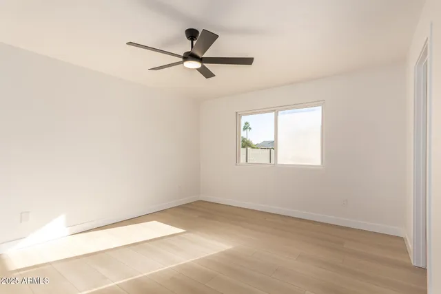 a view of a big room with wooden floor closet and windows