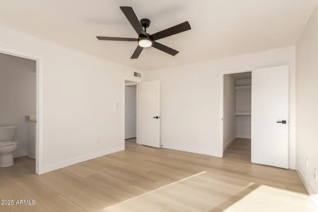a view of a livingroom with a ceiling fan and entryway