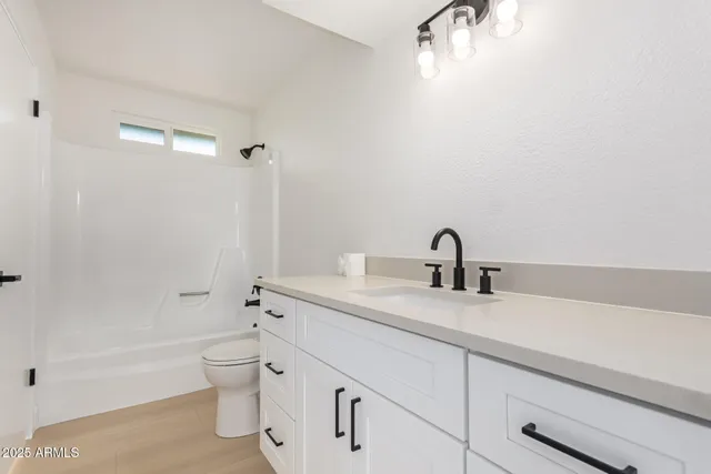 a bathroom with a sink a toilet and a bathtub
