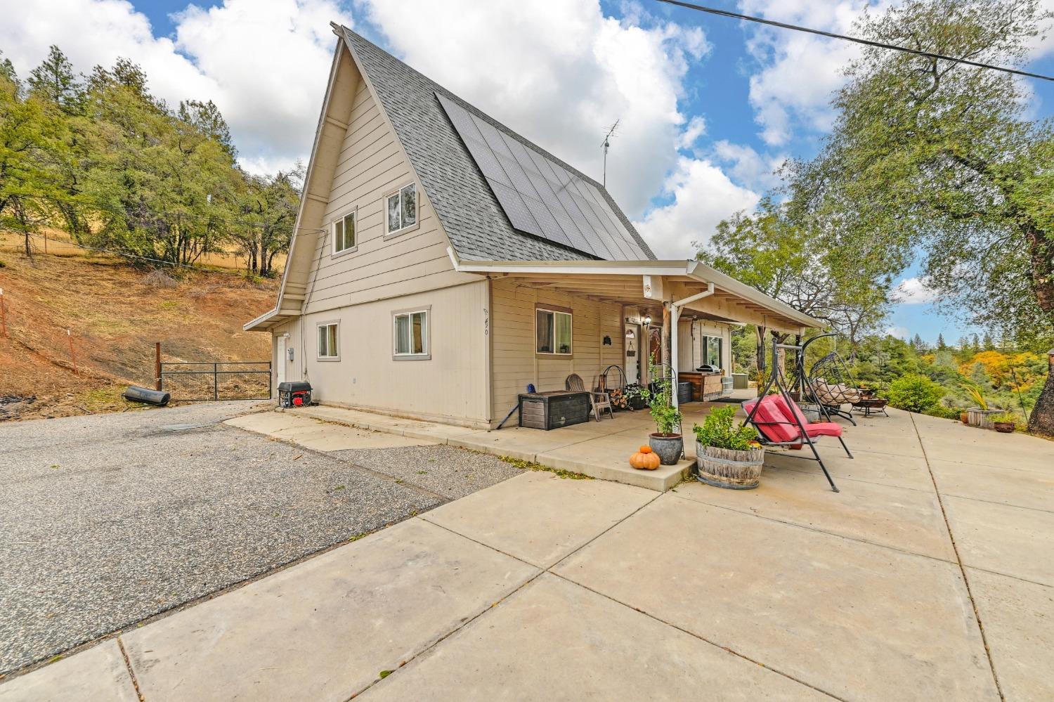 490 Mount Howell Road Colfax, CA 95713 - Photo 1 of 1 a backyard of a house with outdoor seating