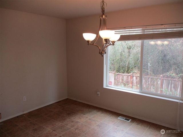a view of a room with a window and ceiling fan