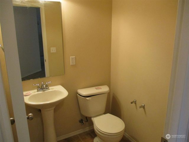 a bathroom with a sink a toilet and a mirror