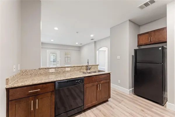a kitchen with a sink and refrigerator