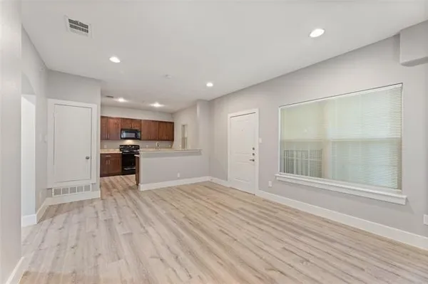 a view of kitchen with microwave and refrigerator
