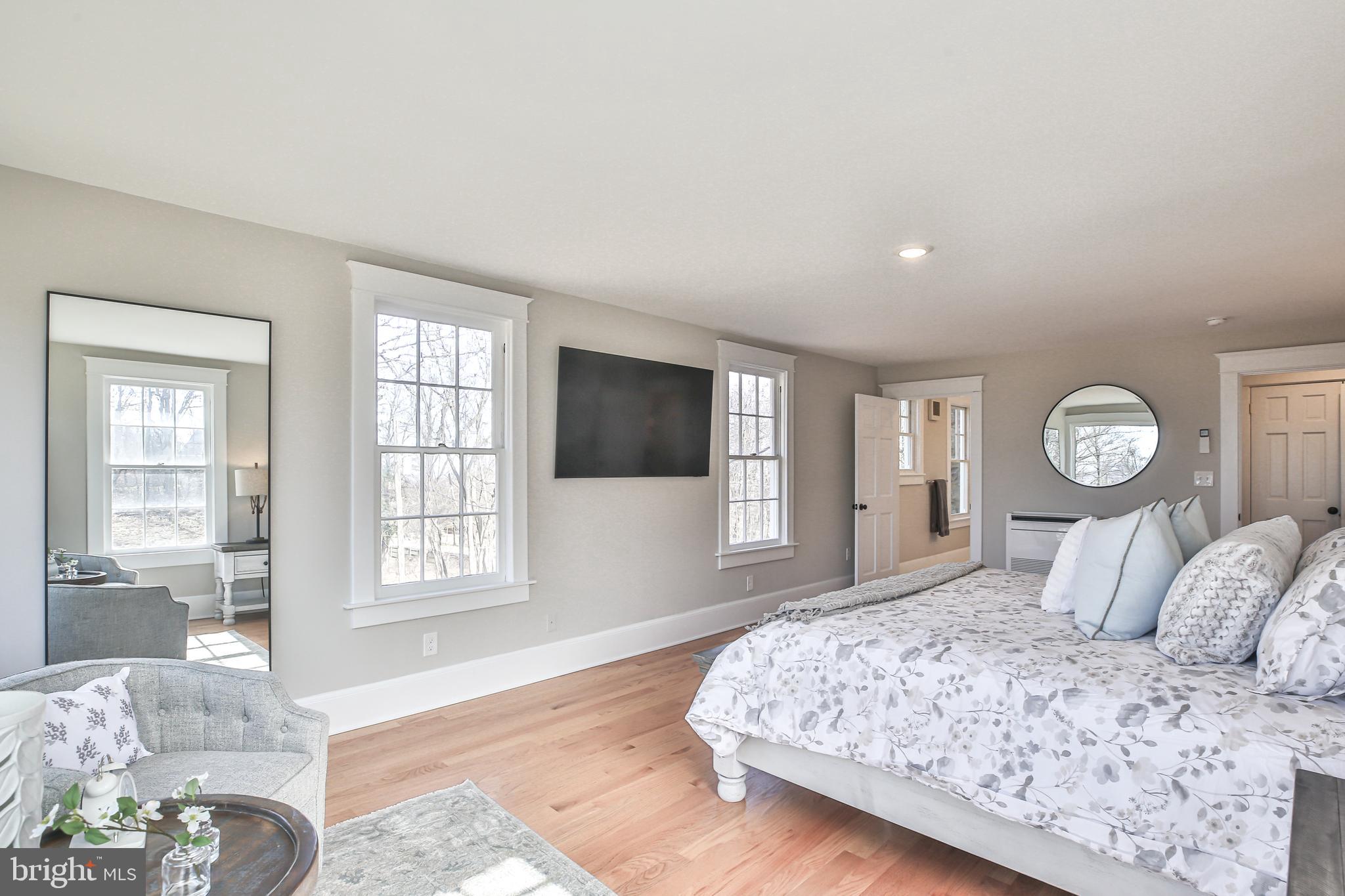 17345 Raven Rocks Road Bluemont, VA 20135 - Photo 50 of 99 a bedroom with a large bed and wooden floor