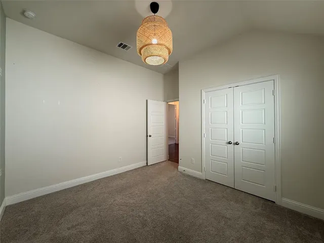 an empty room with windows and mirror