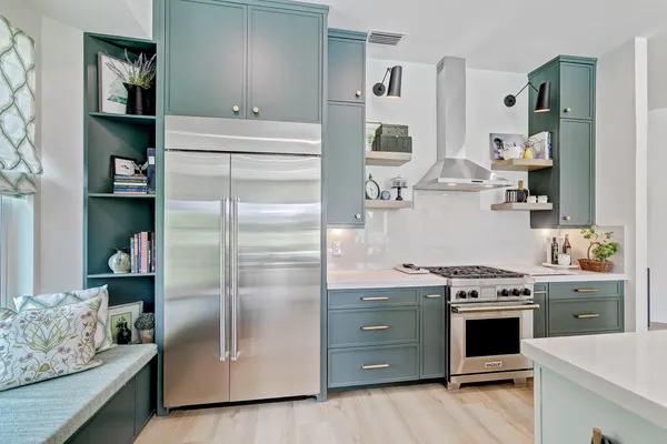 a kitchen with stainless steel appliances kitchen island granite countertop a refrigerator and a stove