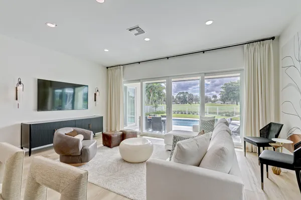 a living room with furniture and kitchen view
