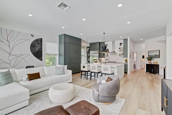 a living room with a large window and a floor to ceiling window