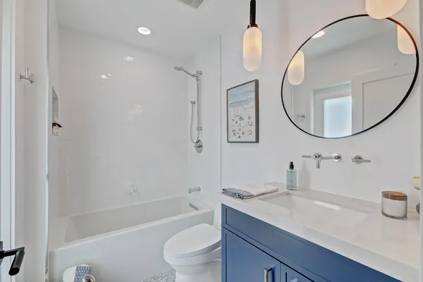 a spacious bedroom with a large bed and a large window