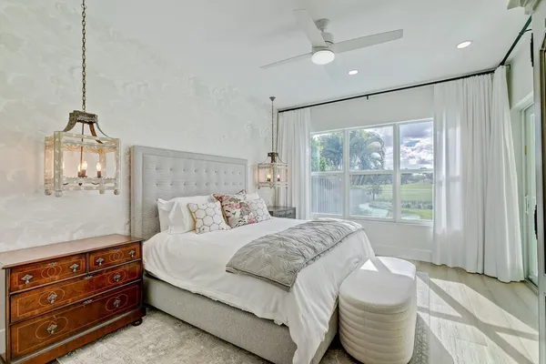 a view of a swimming pool and lounge chairs in back yard of the house