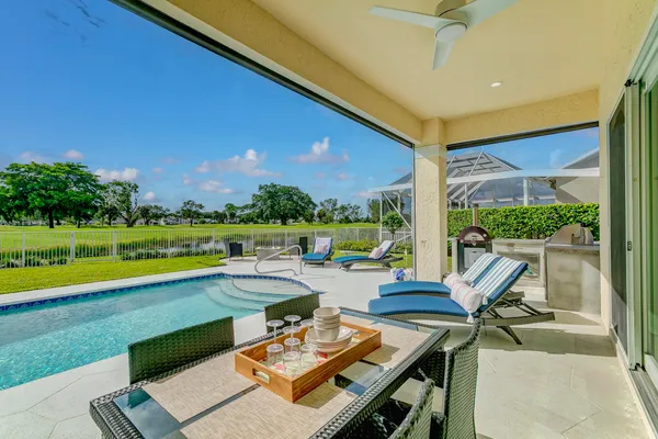 an aerial view of a house with a garden and large trees