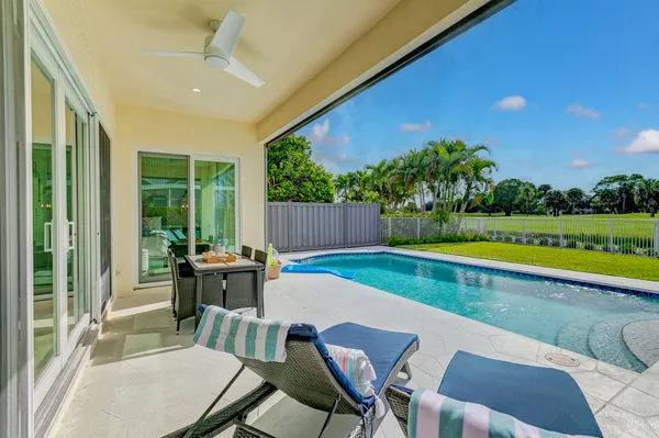 an aerial view of residential houses with outdoor space and ocean view