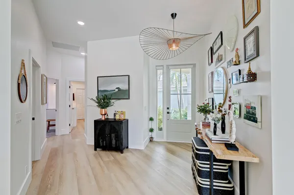 a living room with furniture a dining table and wooden floor