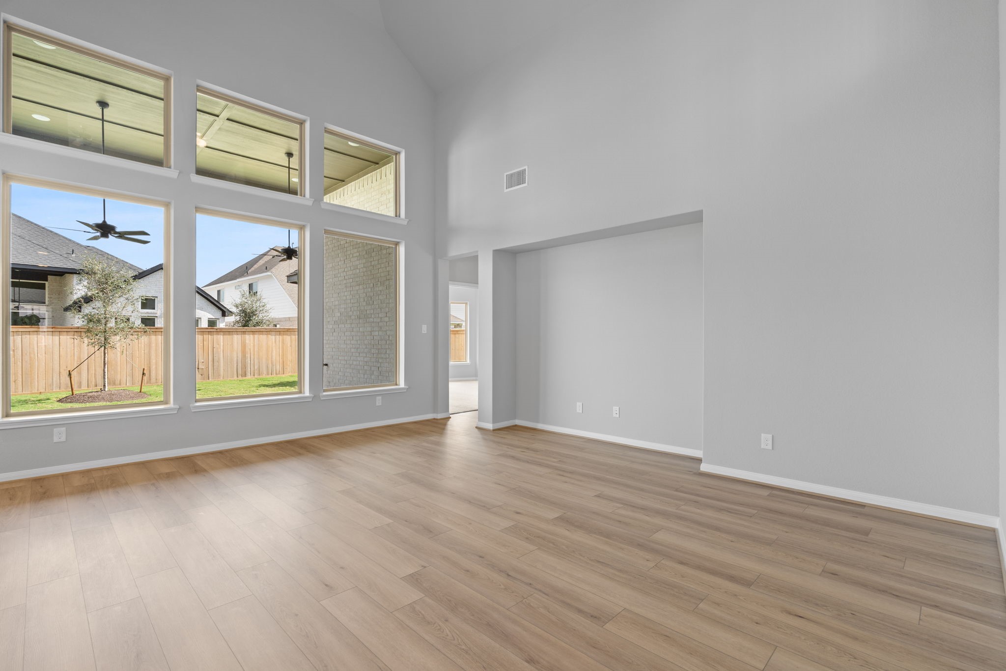10726 Rattlebox Court Cypress, TX 77433 - Photo 12 of 36 a view of an empty room with a window and wooden floor