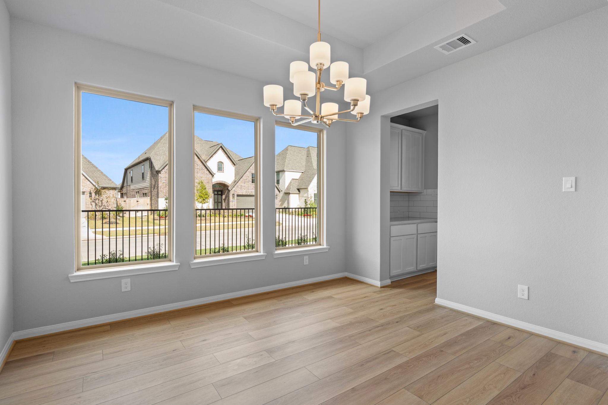 10726 Rattlebox Court Cypress, TX 77433 - Photo 13 of 36 a view of an empty room with a window and wooden floor