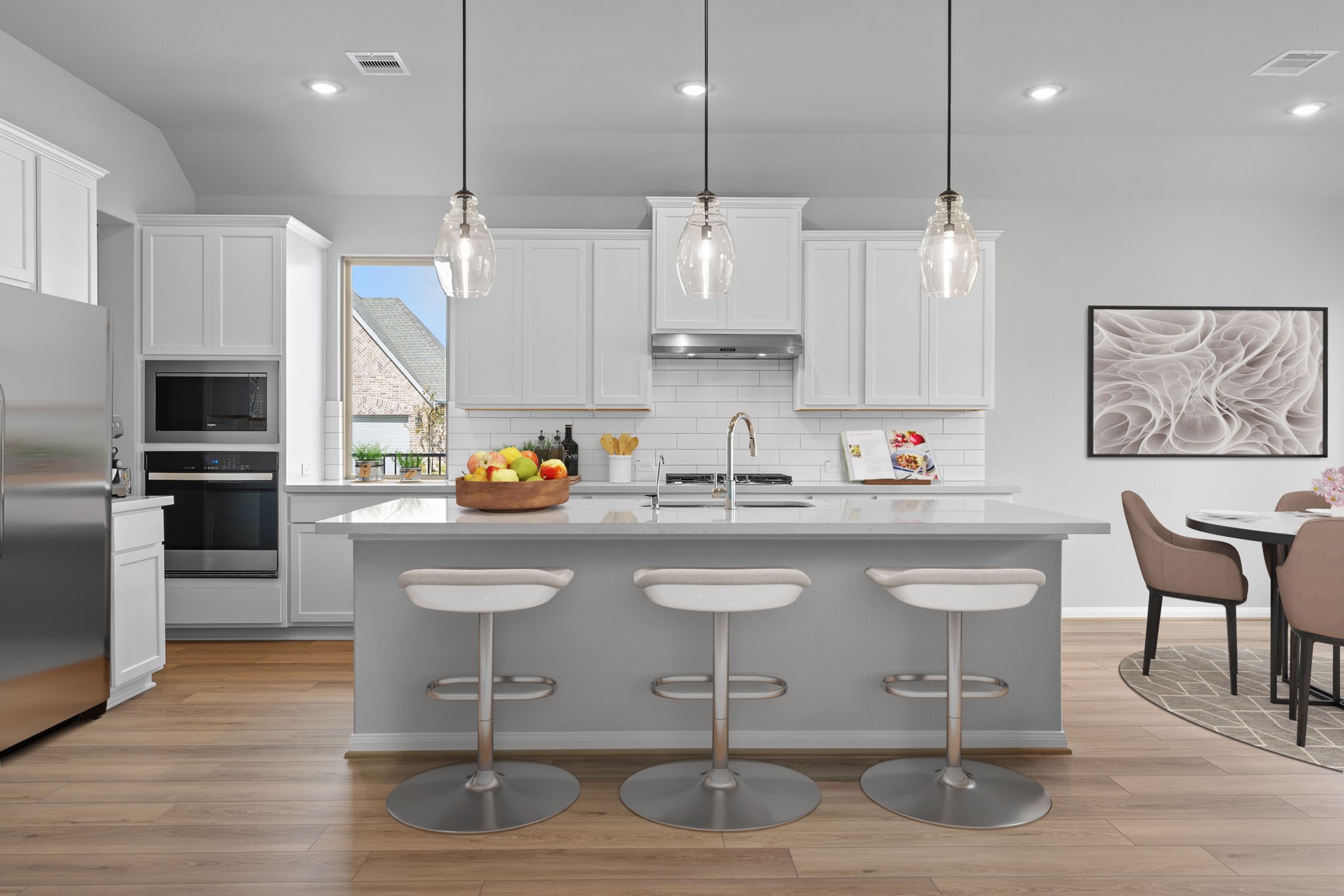 10726 Rattlebox Court Cypress, TX 77433 - Photo 2 of 36 a kitchen with stainless steel appliances granite countertop a table chairs sink refrigerator and microwave