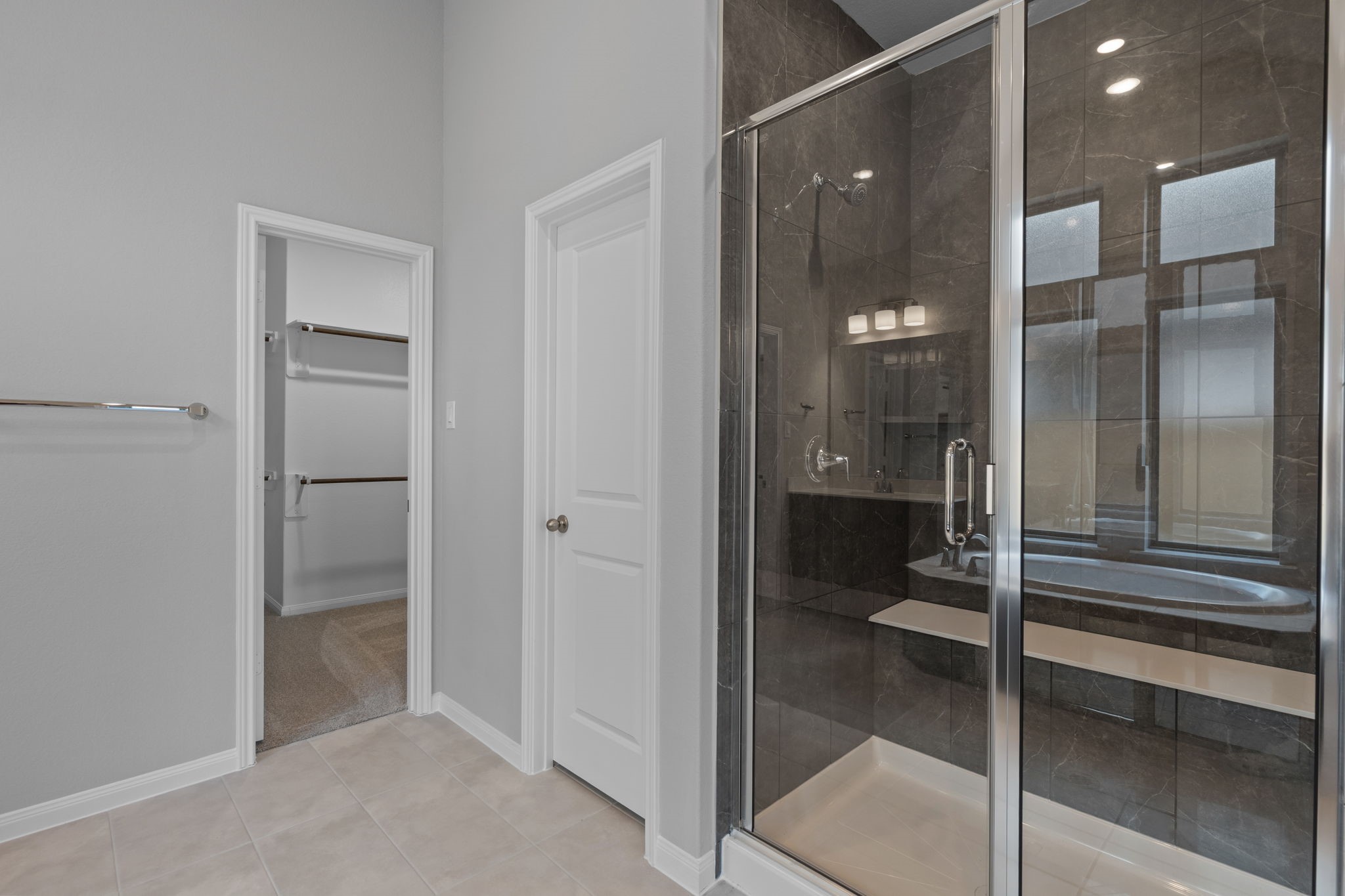 10726 Rattlebox Court Cypress, TX 77433 - Photo 23 of 36 a bathroom with a glass shower door