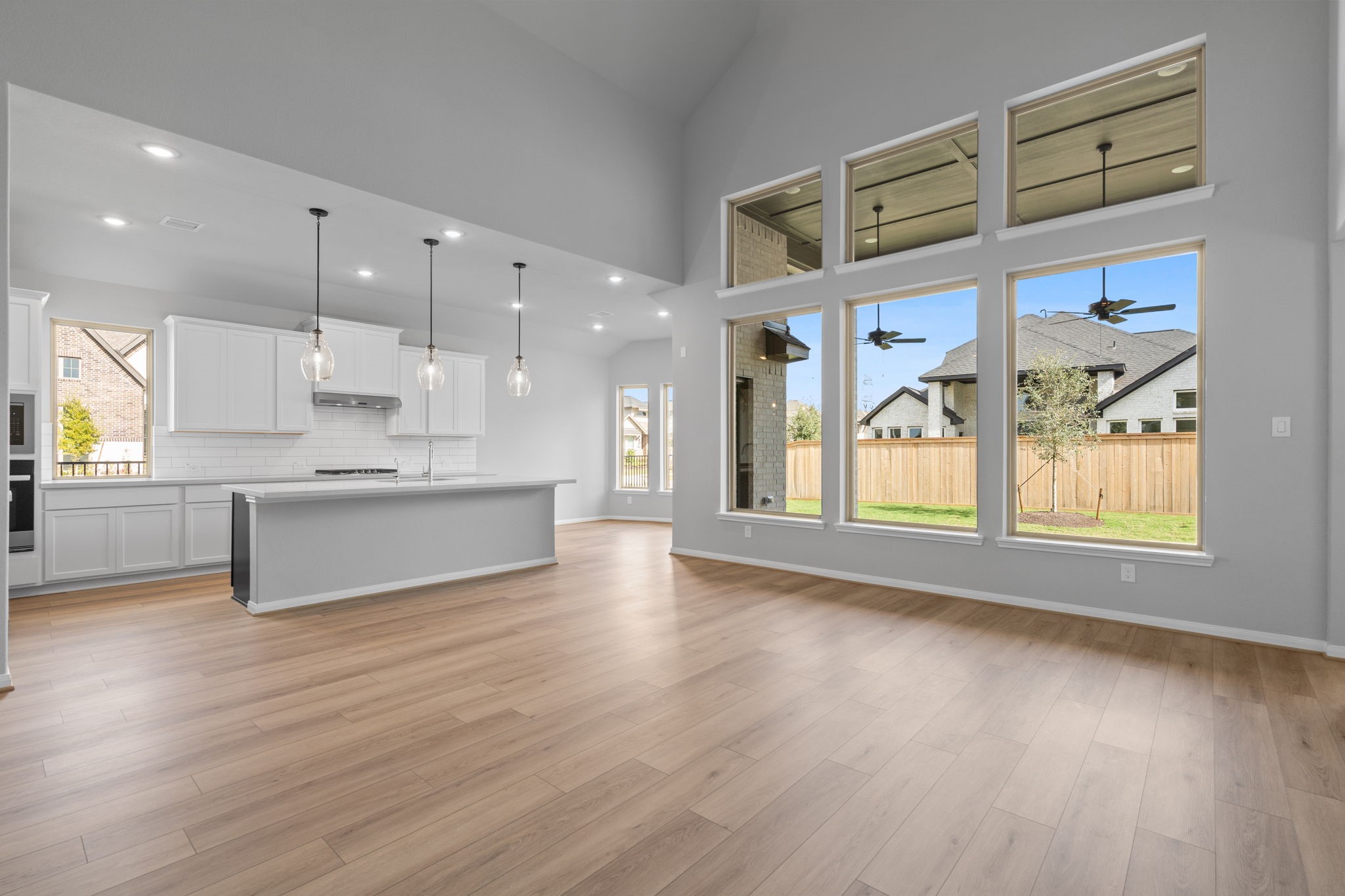 10726 Rattlebox Court Cypress, TX 77433 - Photo 9 of 36 a large kitchen with stainless steel appliances kitchen island a large counter top and a wooden floors