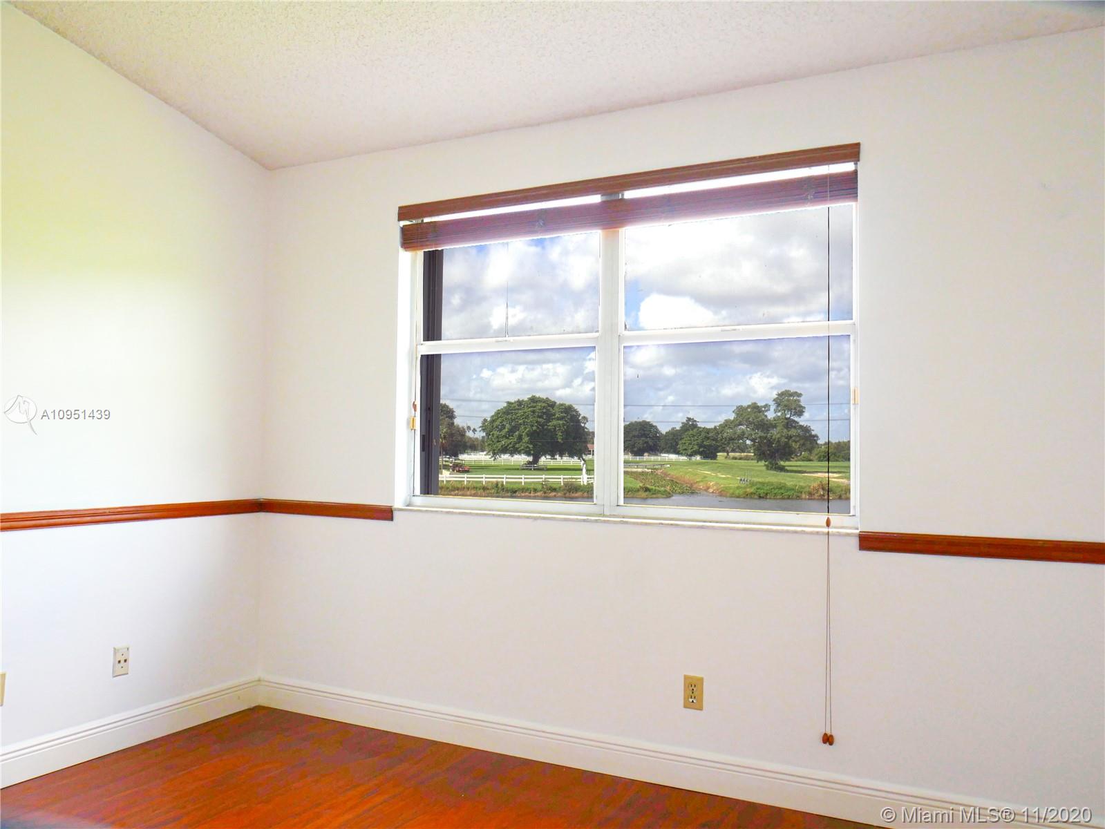 4709 Grapevine Way Davie, FL 33331 - Photo 25 of 41 Part of master bedroom overlooking lake and horse ranch.