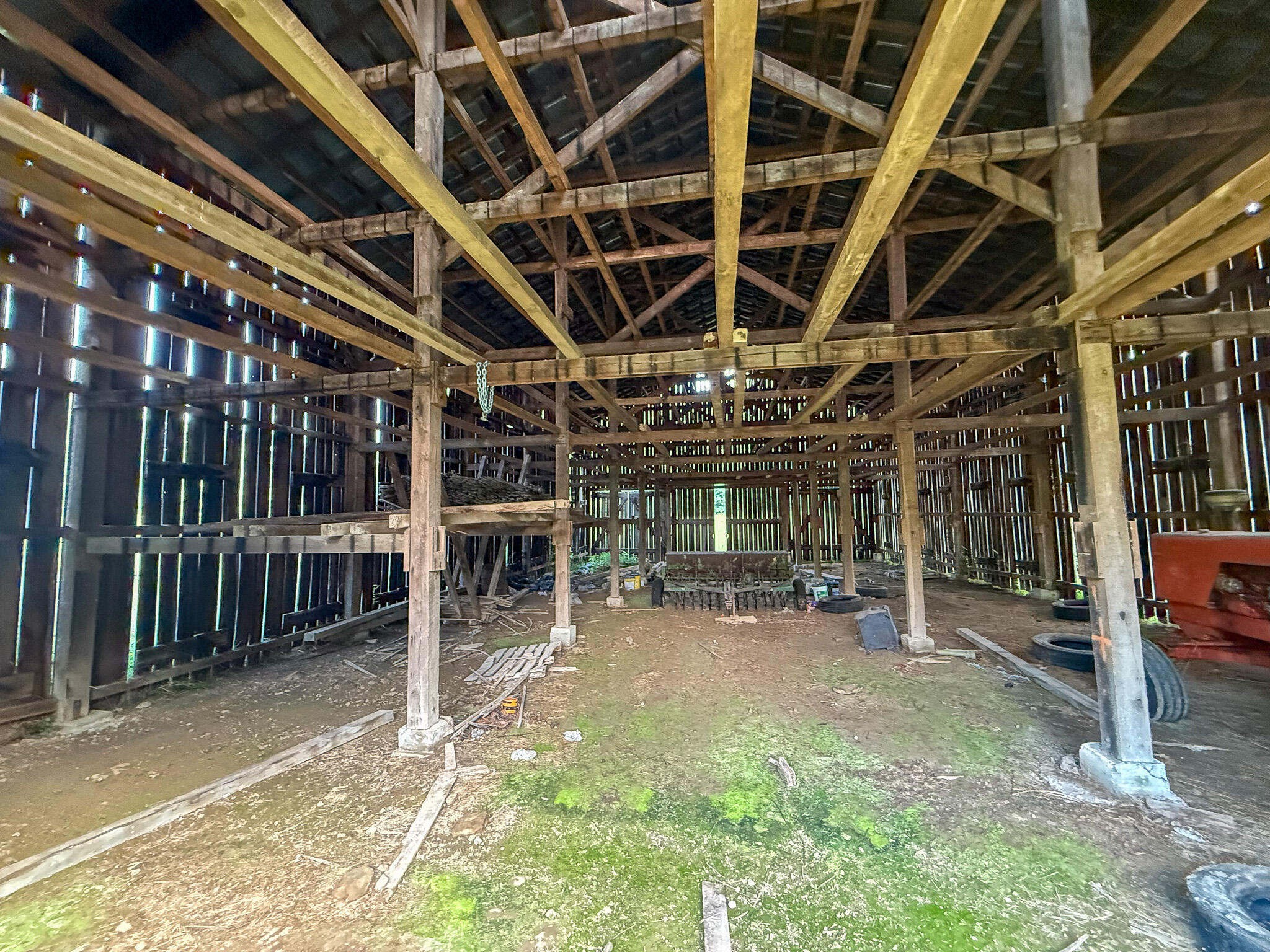 0 Thorp Ridge Wallingford, KY 41093 - Photo 21 of 28 Spacious barn interior featuring exposed timber framing, vertical wood slat walls, a high gabled ceiling, and a dirt floor