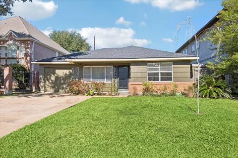 a view of a house with backyard sitting area and garden