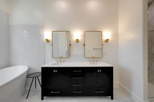 a bathroom with a double vanity sink and a mirror