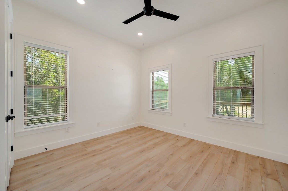 2 Cherokee Trail Wimberley, TX 78676 - Photo 17 of 26 a view of an empty room with wooden floor and a window