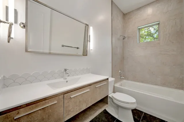 a bathroom with a sink toilet and bathtub