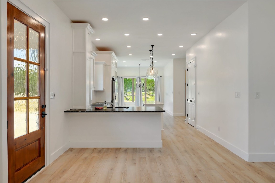 2 Cherokee Trail Wimberley, TX 78676 - Photo 7 of 26 a view of kitchen with wooden floor and window