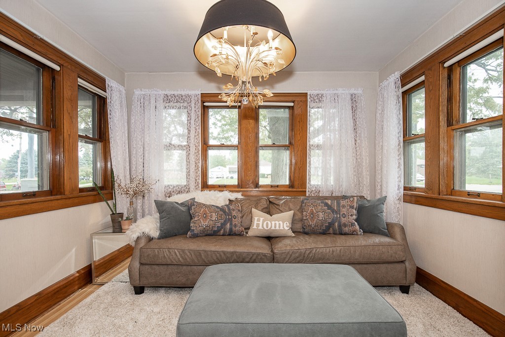 7070 Ridge Road Parma, OH 44129 - Photo 4 of 28 Living room featuring a notable chandelier and light hardwood / wood-style floors