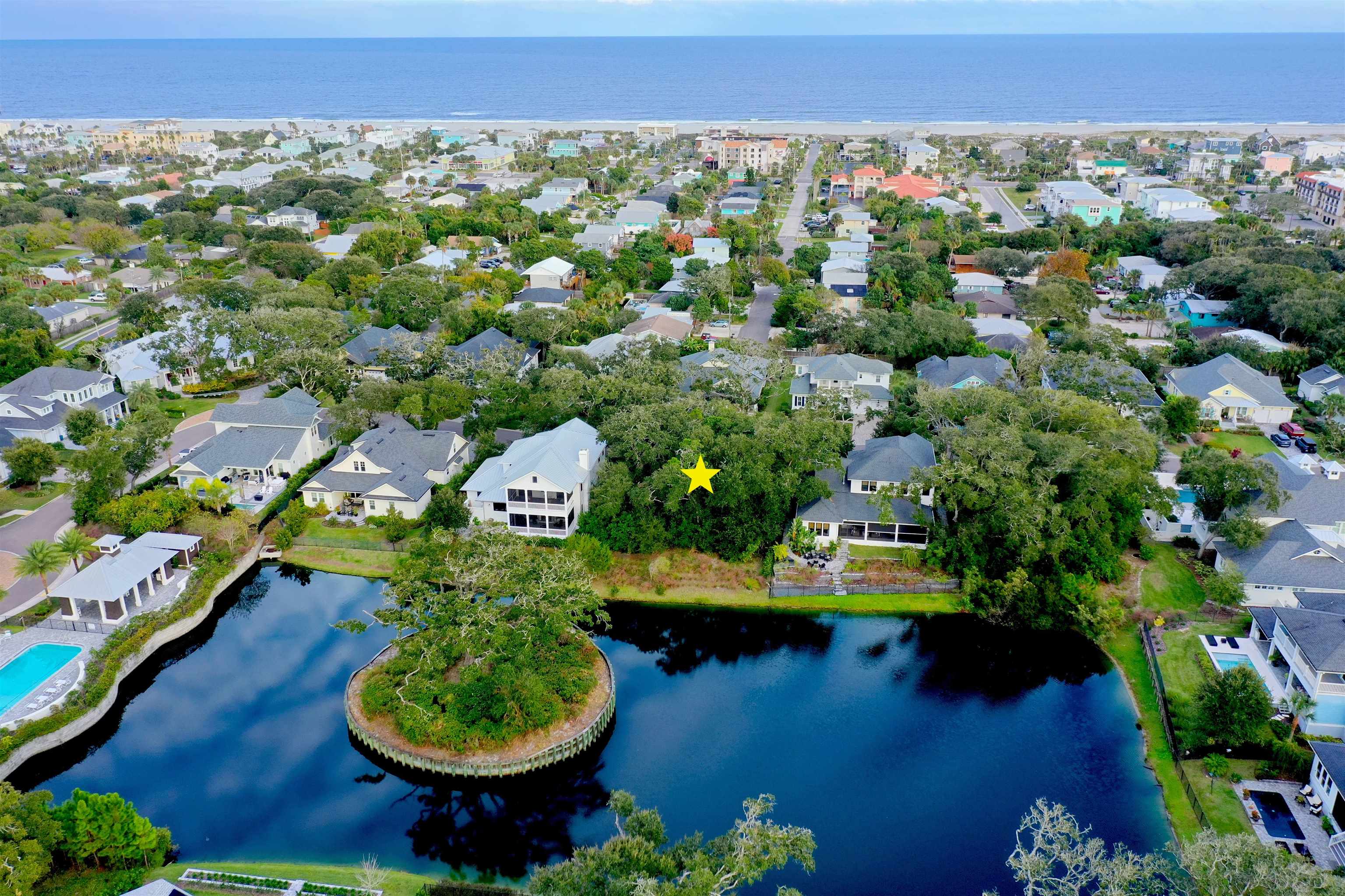 an aerial view of a house with a yard and lake view