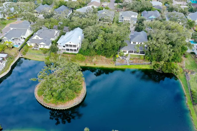 an aerial view of a house with swimming pool and lake view