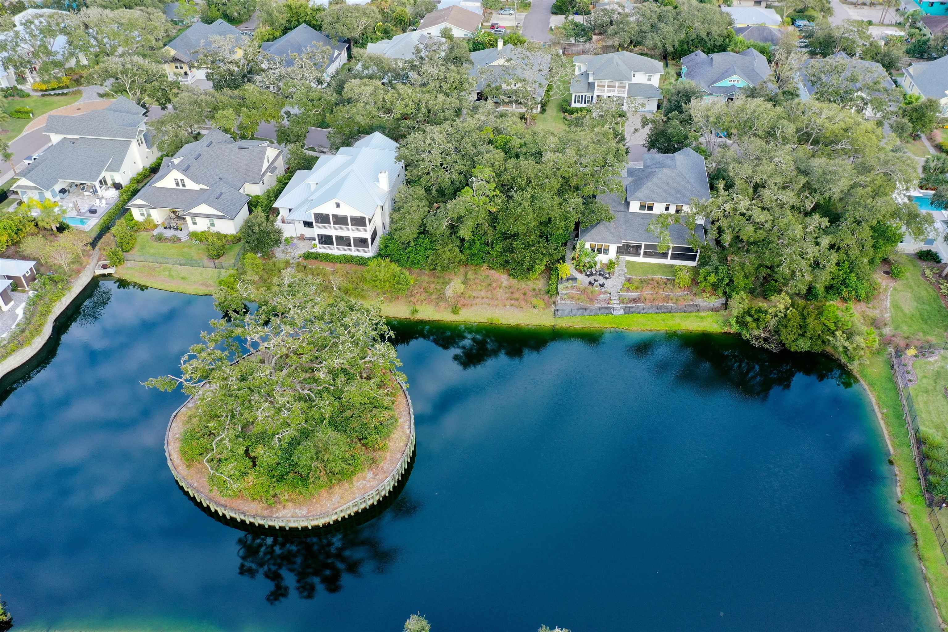 489 Ridgeway Road St. Augustine, FL 32080 - Photo 9 of 20 an aerial view of a house with swimming pool and lake view