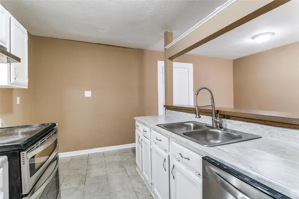 a kitchen with a sink and cabinets